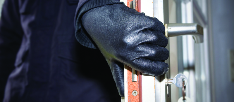 Burglar breaking into a house